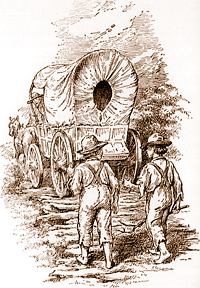 Two boys walking behind covered wagon.